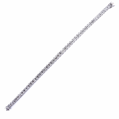 1112 - A baguette diamond tennis line bracelet, circa 1960, total diamond content approx 15ct, set with 50 ... 