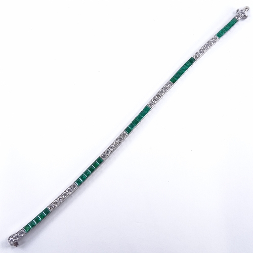 1113 - An emerald and diamond tennis line bracelet, set at alternates with calibre-cut emeralds and round b... 