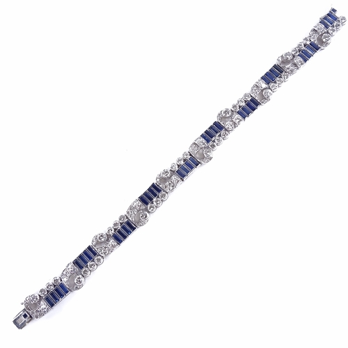 1115 - An Art Deco sapphire and diamond bracelet, circa 1930s, geometric and scroll form, set with rectangu... 