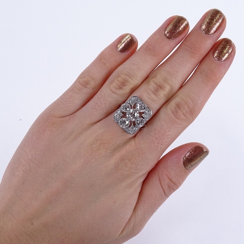 1125 - An Art Deco diamond cluster panel ring, circa 1920, geometric quatrefoil form set with old-cut diamo... 