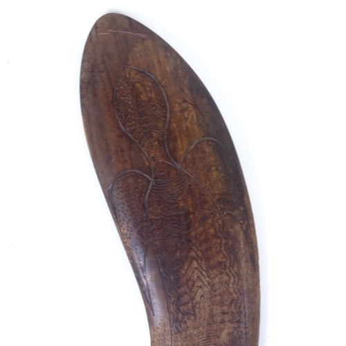 69 - A Tribal hardwood throwing spear/boomerang, with engraved stylised turtle design, probably 20th cent... 