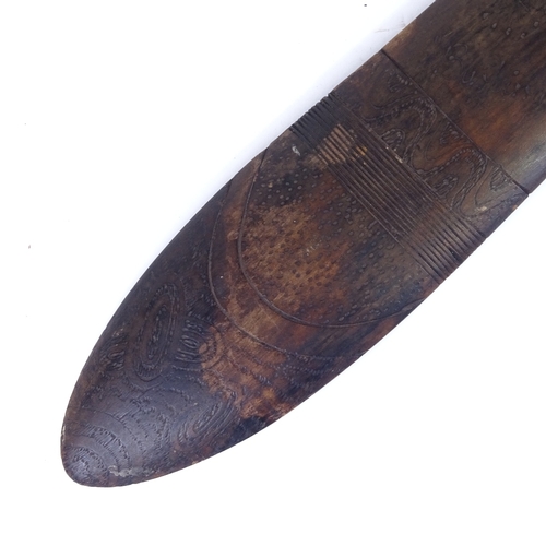 69 - A Tribal hardwood throwing spear/boomerang, with engraved stylised turtle design, probably 20th cent... 