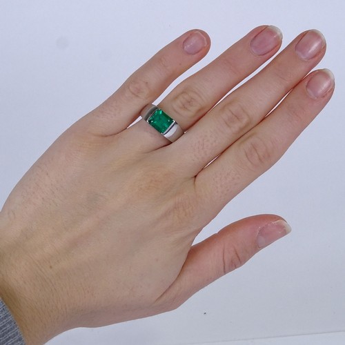 1134 - A Colombian emerald ring, rectangular emerald-cut emerald weighing approx 2.42ct bezel-set in heavy ... 