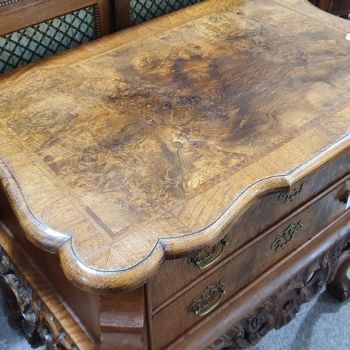 348 - A Continental crossbanded walnut chest of 2 drawers, with shaped top, carved apron and cabriole legs... 