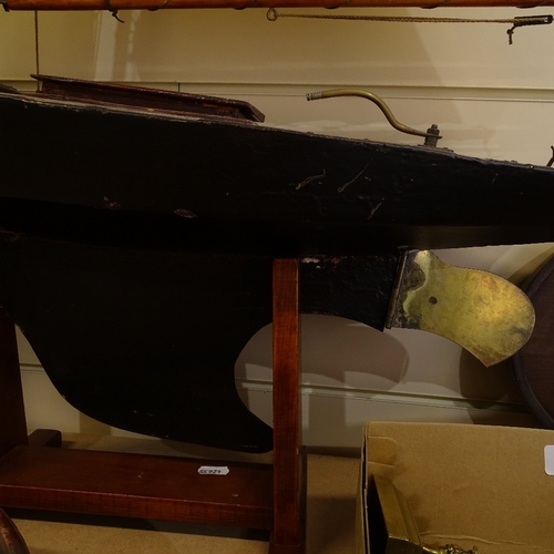 107 - A 19th century black lacquered wooden-hulled model pond yacht, with sails and rigging, hull length 8... 