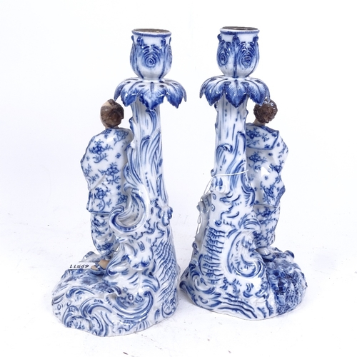 191 - A pair of 19th century blue and white porcelain figural candlesticks, depicting Chinese figures, blu... 