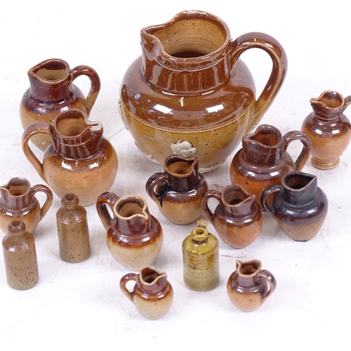 238 - A group of miniature stoneware jugs and ginger beer bottles, including some Royal Doulton (15)