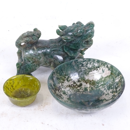 250 - A Chinese miniature carved and polished jadeite temple dog, a moss agate bowl, and another (3)