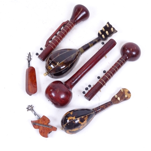 269 - A group of miniature mother-of-pearl tortoiseshell and wood mandolins, largest length 17cm (7)