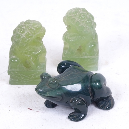 284 - A pair of carved jadeite Dogs of Fo, and a green agate frog, length 6cm (3)