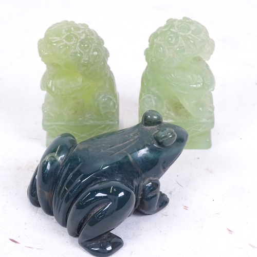 284 - A pair of carved jadeite Dogs of Fo, and a green agate frog, length 6cm (3)