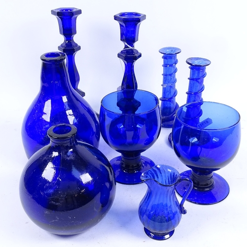 297 - A group of Bristol blue glassware, including candlesticks, rummers, bottles etc (9)