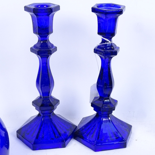 297 - A group of Bristol blue glassware, including candlesticks, rummers, bottles etc (9)