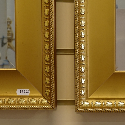 64 - A modern pair of rectangular gilt-framed bevel-edge wall mirrors, 74cm x 64cm