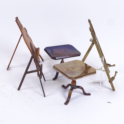 77 - A pair of brass doll's house tilt-top tables, and 3 miniature easels, largest height 16cm (5)