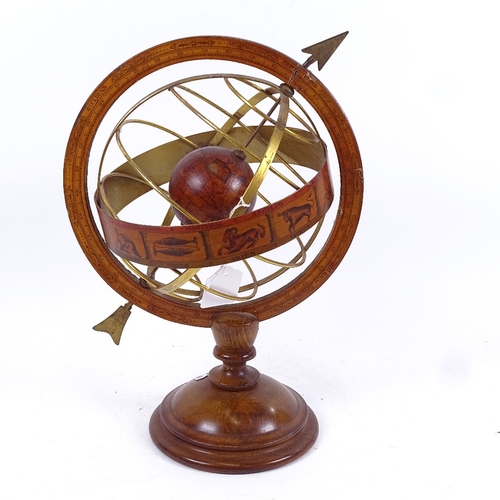 80 - A table-top brass-mounted armillary sphere, with zodiac and turned wood base, height 35cm