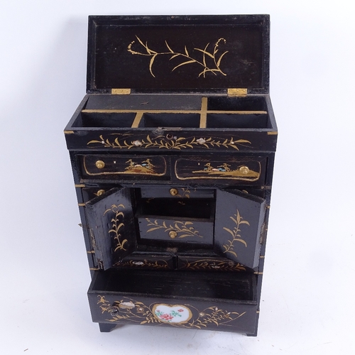 88 - A Japanese gilded black lacquer kodansu table-top jewellery cabinet, hinged lid with drawers and cab... 