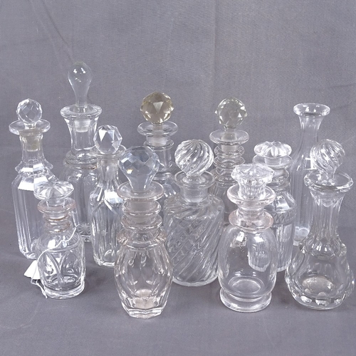 317 - A collection of Victorian and other cut-glass scent bottles and stoppers, tallest 20cm