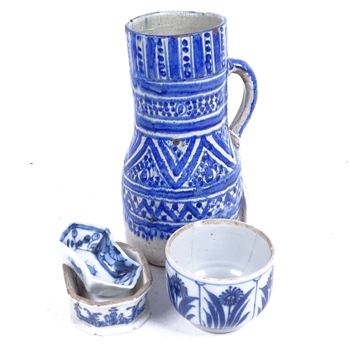 333 - An Oriental blue and white painted jug, 20cm, a pot with floral decoration, salt pot etc (4)