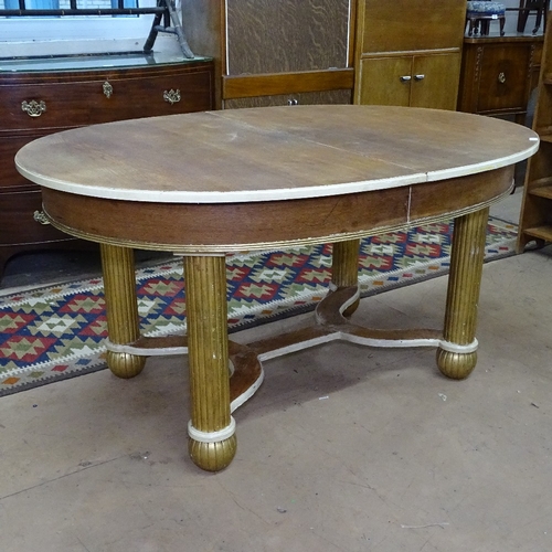 1773 - A 1920s Art Deco oval dining table, with gilt and cream base, L150cm, H77cm, D110cm (no spare leaf f... 