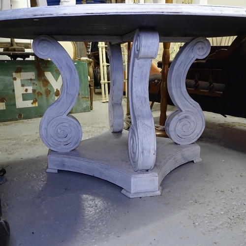 1952 - A large circular white painted dining table, on scrolled platform base, W148cm, H74cm