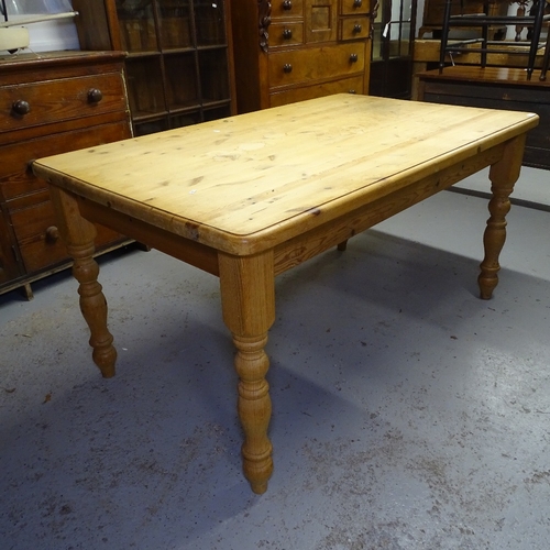 2035 - A polished pine farmhouse kitchen table, on baluster turned legs, L152cm, H77cm, D95cm