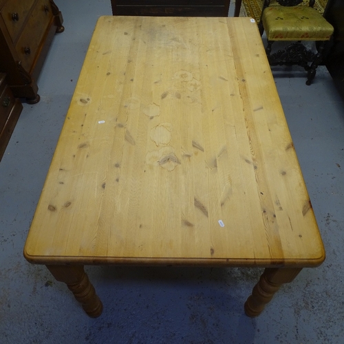 2035 - A polished pine farmhouse kitchen table, on baluster turned legs, L152cm, H77cm, D95cm