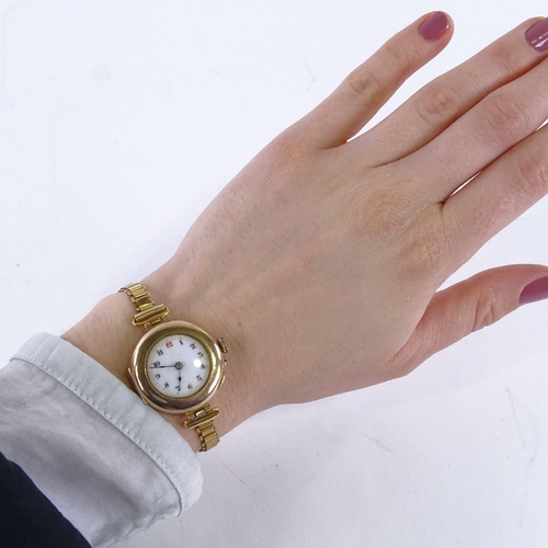 1006 - An early 20th century lady's 9ct rose gold mechanical wristwatch, white enamel dial with Arabic nume... 