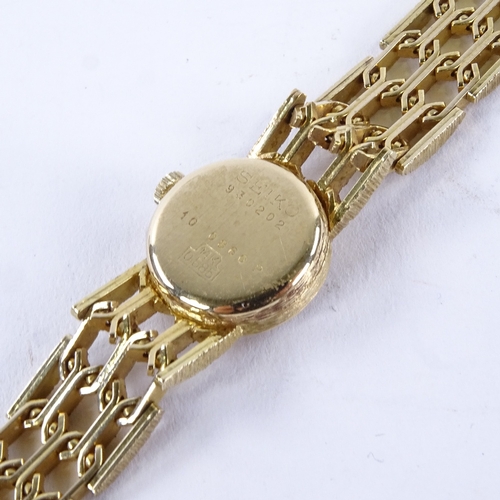 1013 - SEIKO - a lady's Vintage 14ct gold mechanical wristwatch, ref. 10 0860P, silvered dial with gilt bat... 