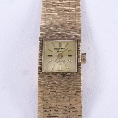 1051 - DELVINA - a lady's Vintage 9ct gold mechanical wristwatch, gilt dial with baton hour markers and 9ct... 