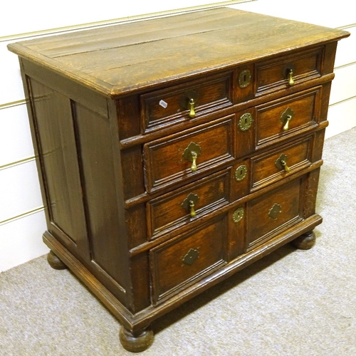 121 - A 17th century joined oak chest of 4 long graduated drawers, with panelled drawer fronts, brass drop... 