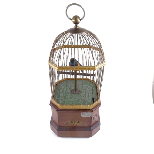 101 - A large Victorian clockwork penny-in-the-slot birdcage automaton, circa 1900, brass wirework cage on... 