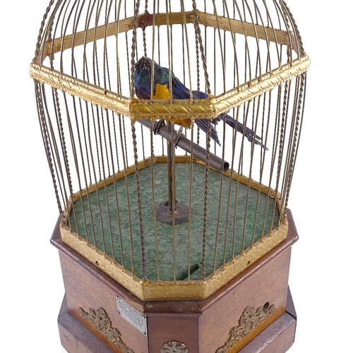 101 - A large Victorian clockwork penny-in-the-slot birdcage automaton, circa 1900, brass wirework cage on... 