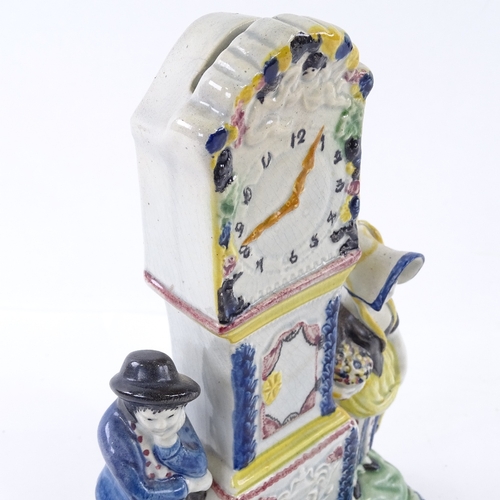 109 - A rare Yorkshire Pratt Ware longcase clock group moneybox, flanked by a pair of figures and a dog in... 