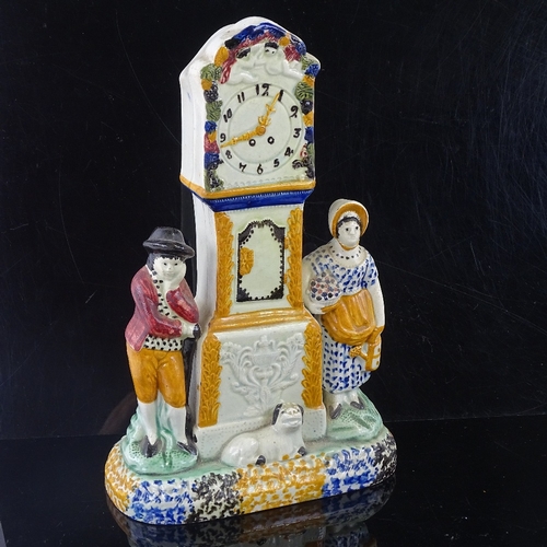 110 - A rare Yorkshire Pratt Ware longcase clock group moneybox, flanked by a pair of figures and a dog in... 