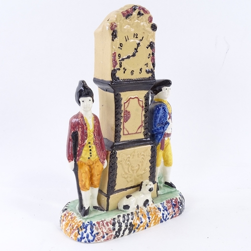 111 - A rare Yorkshire Pratt Ware longcase clock group moneybox, flanked by a pair of figures and a dog in... 