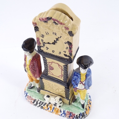 111 - A rare Yorkshire Pratt Ware longcase clock group moneybox, flanked by a pair of figures and a dog in... 