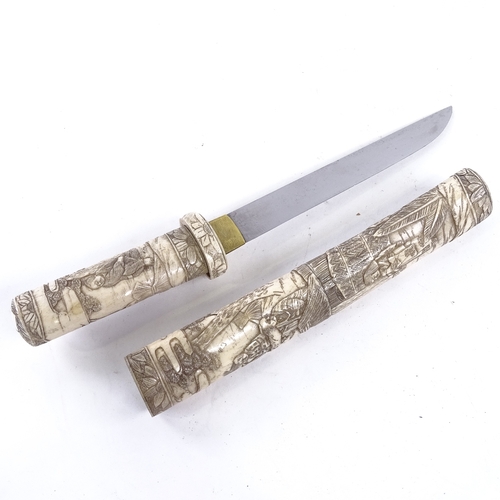 127 - A Japanese Tanto dagger, early 20th century, with relief-carved bone handle and scabbard, overall le... 