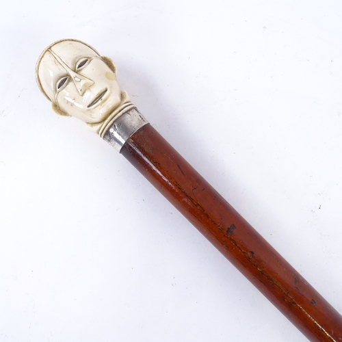 129 - A 19th century malacca walking cane, with stylised carved ivory head knop, 82cm.
