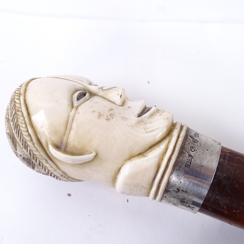 129 - A 19th century malacca walking cane, with stylised carved ivory head knop, 82cm.