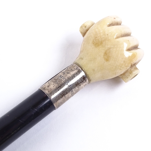 133 - A 19th century ebony walking cane, with marine ivory clenched fist knop and silver collar, by Briggs... 