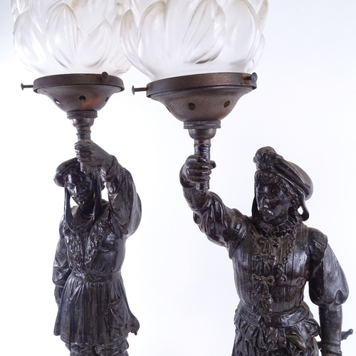 144 - A pair of Victorian spelter figural lamps, with original frosted glass flaming torch shades, overall... 