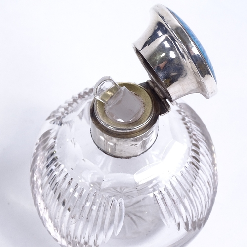 146 - An Edwardian cut glass perfume bottle, with silver and blue enamel top, height 10cm.