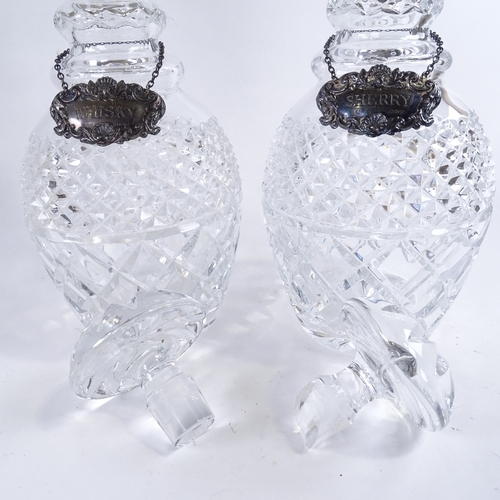 147 - A pair of cut glass silver mounted decanters, with silver labels, height 29cm.