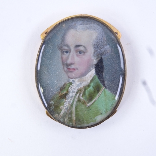 72 - A Georgian miniature watercolour on ivory, head and shoulders portrait of a gentleman wearing a gree... 