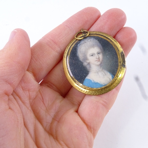 73 - A Georgian miniature watercolour on ivory, head and shoulders portrait of a lady wearing a blue dres... 