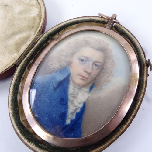 77 - A Georgian miniature watercolour on ivory, portrait of a gentleman wearing a blue coat with frilled ... 
