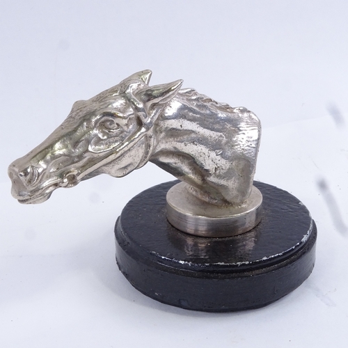 96 - A nickel plate racing horse head car mascot, on painted metal base, overall height 8.5cm.
