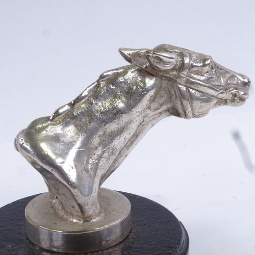 96 - A nickel plate racing horse head car mascot, on painted metal base, overall height 8.5cm.