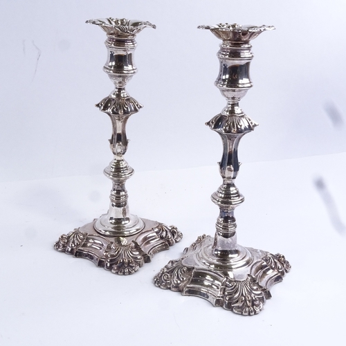 97 - A pair of 19th century silver plated candlesticks, square bases with squirrel armorial crests, heigh... 